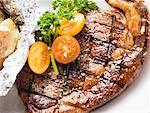 Grilled rump steak with tomatoes and baked potato