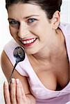 Woman licking yoghurt from a spoon