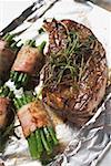 Grilled beef steak with bacon- wrapped beans