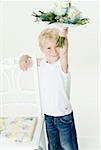 Blond boy with bouquet of white roses