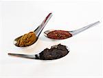 Three Asian spice pastes on spoons