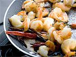Fried shrimps with chili peppers in frying pan