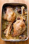 Roast goose legs in roasting tin