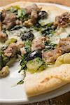 Pizza with tuna, chard and olives a slice taken