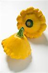 Two yellow patty pan squashes