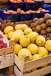 Lemons, kiwi fruits and apricots at a market