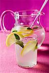 Lemonade with ice cubes and lemon balm