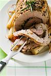 Roast turkey roll with root vegetables and herbs