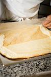 Pulling baking parchment off sponge base