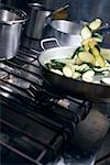Tossing courgette slices in frying pan