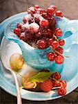 Redcurrants in glass jug, sugar, gooseberries, raspberry