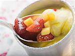 Mango cream with strawberries and icing sugar