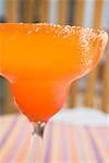 Margarita in orange glass with salted rim