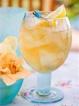 Fruity pineapple drink with ice cubes and lemon