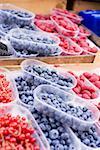 Assorted berries in punnets at a market