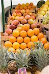Fruit stall with oranges, pineapples and apples