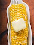 Corn on the cob with knob of melting butter (overhead view)