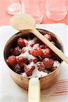 Sugared raspberries in a pan, empty jam jars