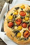Pizza with cherry tomatoes, capers and rosemary