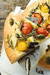 Pizza with cherry tomatoes, capers & rosemary (slice on server)