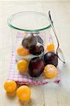 Plums, mirabelles, sugar, jam jar and spoon