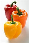 Yellow, orange and red peppers with drops of water