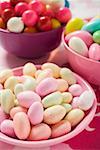 Different kinds of sweets and bubble gum balls in bowls