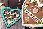 Two women in national dress with Lebkuchen hearts at Oktoberfest