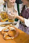 Two women clinking litres of beer at Oktoberfest