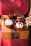 Woman offering chocolates on gift box