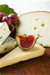 Cheese still life with fig and grapes