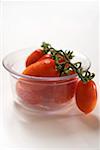 Plum tomatoes in a glass bowl