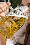 Woman drinking a litre of light beer (Oktoberfest, Munich)