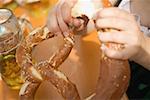 Hands breaking a soft pretzel (Oktoberfest, Munich)