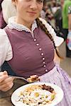 Woman eating emperor's pancake (Oktoberfest, Munich)