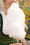 Woman eating candyfloss (Oktoberfest, Munich)