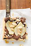 Piece of pear and chocolate tart with almonds