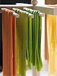 Home-made ribbon pasta hanging up to dry