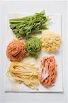 Home-made coloured pasta on tea towel