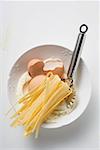 Home-made ribbon pasta, ingredients and pasta wheel