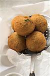 Falafel (chick-pea balls) on slotted spoon