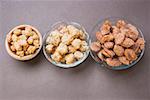 Assorted nuts to nibble in bowls