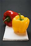 Two peppers (yellow, red) on white linen cloth