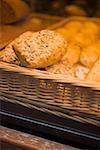 Assorted bread rolls in a basket at a market