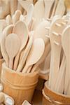 Wooden spoons in wooden buckets at a market