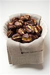 Roasted chestnuts on cloth in white bowl