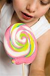 Child holding pastel-coloured lollipop