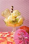 Ice cream sundae with fresh fruit cocktail umbrella