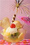 Ice cream sundae with fresh fruit and cocktail umbrella