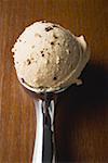 Scoop of ice cream in ice cream scoop (overhead view)